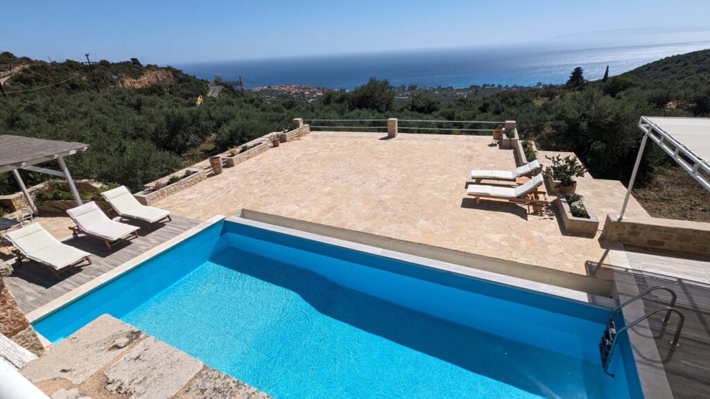 Private pool and stone terrace at Villa Leonidas overlooking the coastline and Kardamili village.