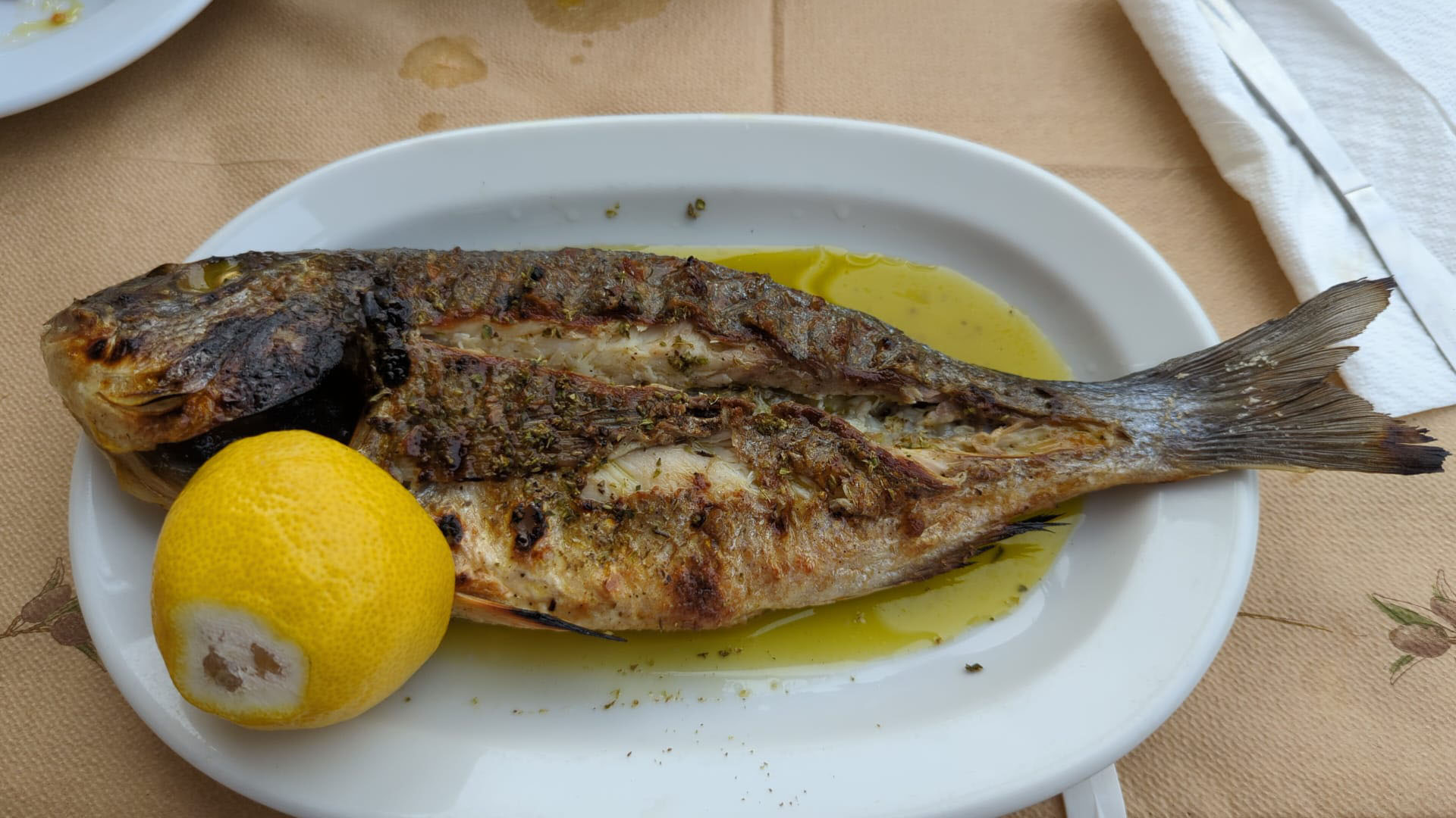 Grilled whole fish with lemon served at Kiki’s Taverna in Kardamili