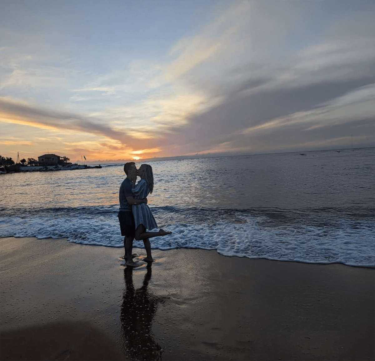 Couple embracing on a beach at sunset in Kardamili, ideal setting for a romantic getaway