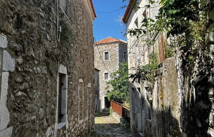 Narrow stone alleyway in Thalames village along the Trachila hiking loop