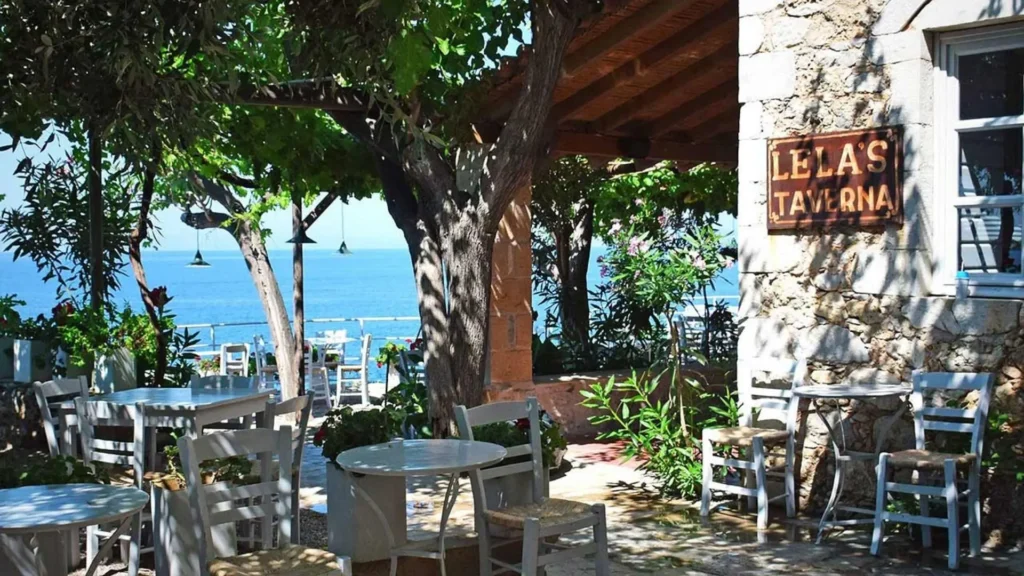 Lela’s Taverna in Kardamyli with shaded outdoor seating and sea views, offering authentic Greek dining.