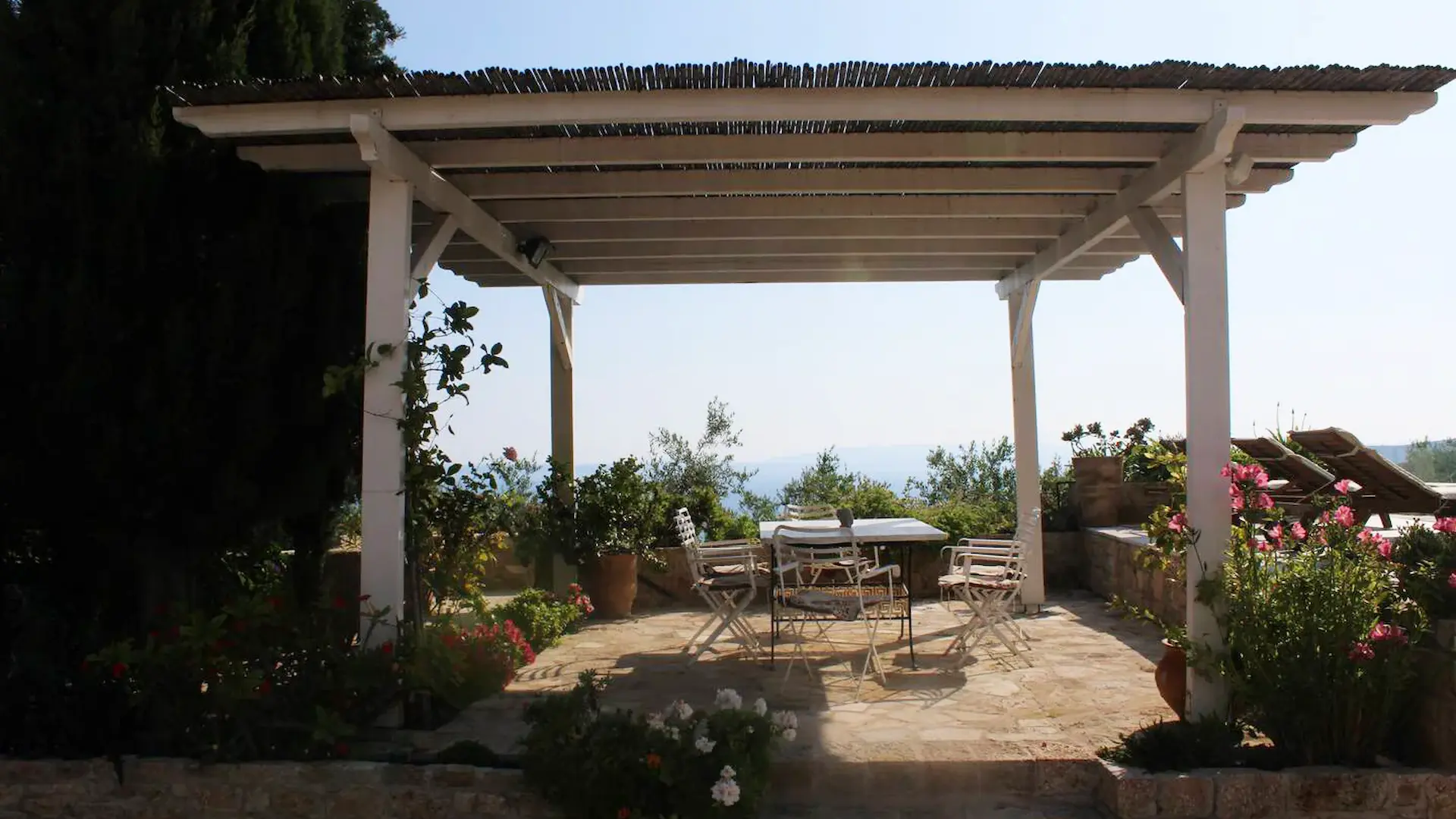 Poolside ocean view dining area at Villa Leonidas in Kardamyl
