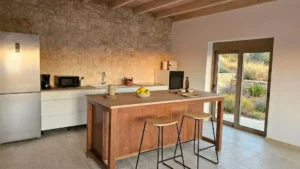 Modern Mediterranean kitchen with island seating in Kardamili