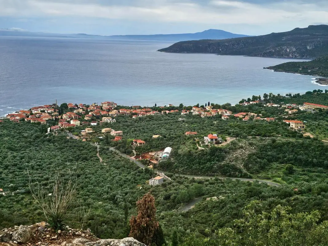 Aerial view of the dramatic Mani coastline and stone villages in Kardamili, showcasing the authentic landscape surrounding premium villas for rent.