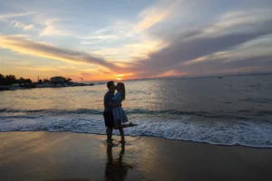 Romantic week in Kardamyli with a couple walking beside the sea at sunset