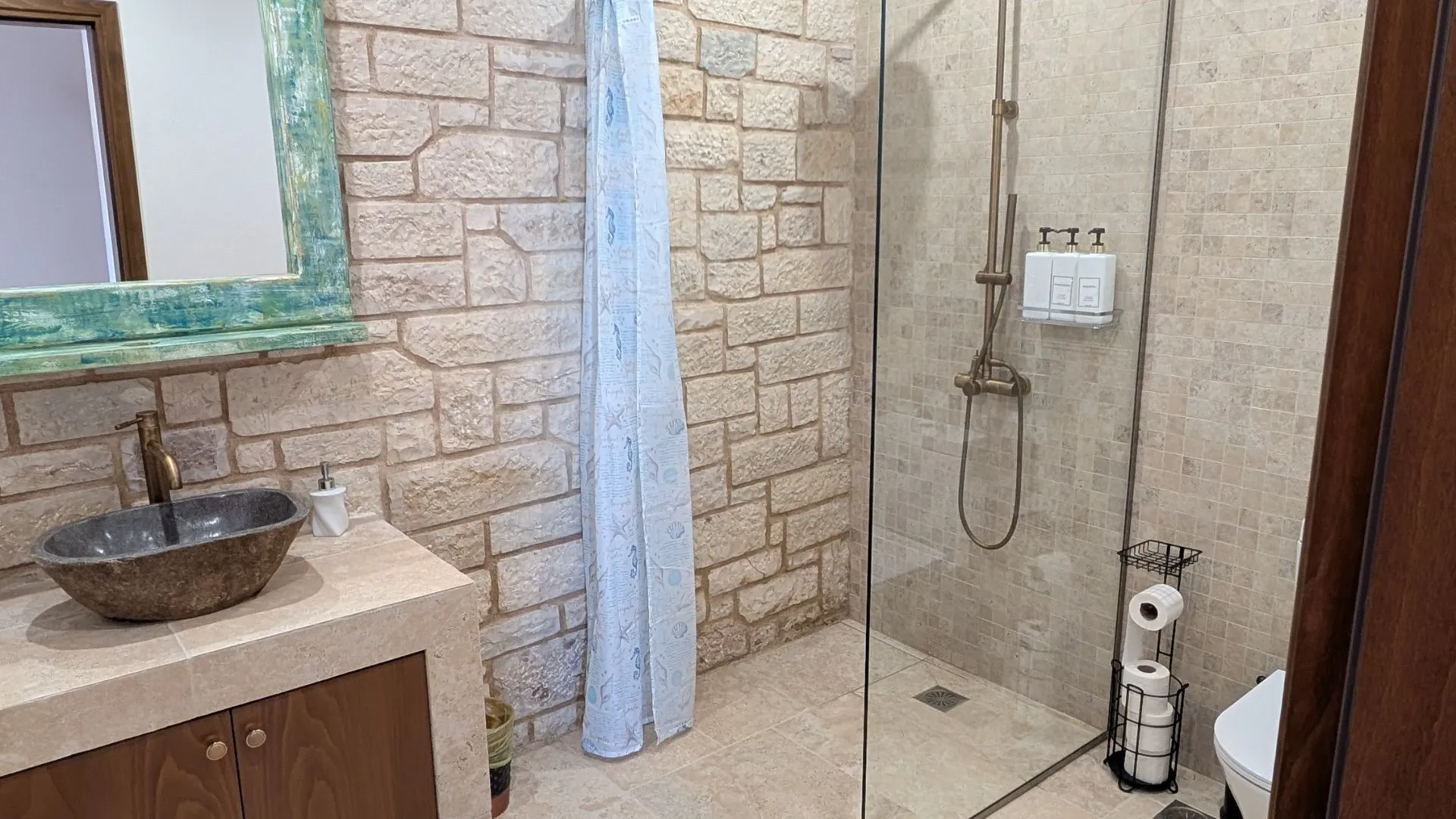 Achilles Cottage bathroom with stone vessel sink and walk-in shower