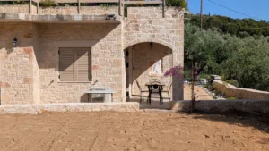 Achilles Cottage Kardamyli stone exterior with arched entrance