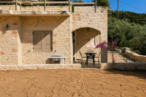 Achilles Cottage stone exterior and garden in Kardamili