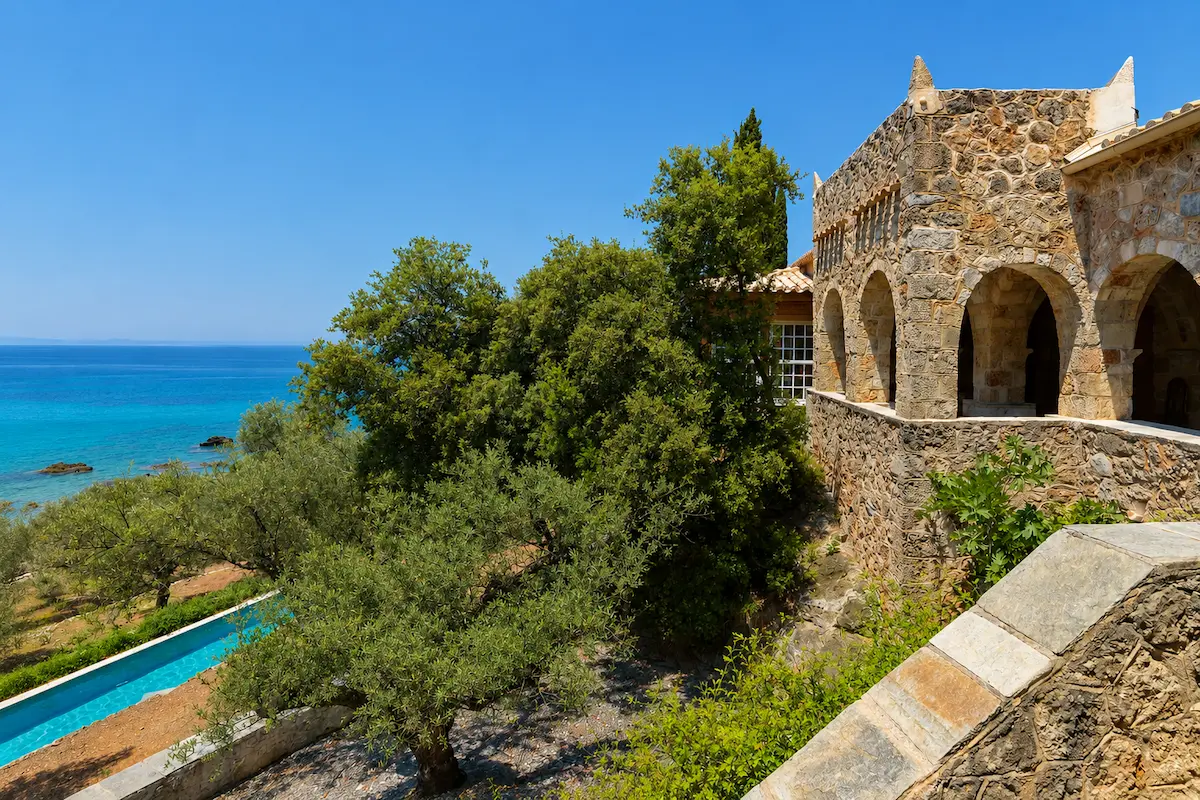 Patrick Leigh Fermor House at Kalamitsi, stone exterior with cypresses, Kardamyli