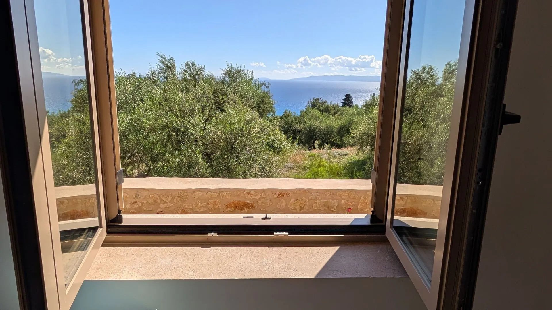 Sea view from Achilles Cottage window over olive groves in Kardamyli