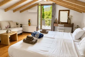 Guest House attic bedroom with balcony at Villa Leonidas in Kardamyli