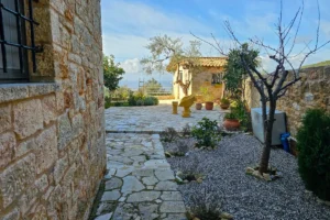Stone walkway connecting buildings at the Villa Leonidas estate